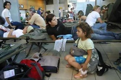 French nationals wait for flights out of the Ivory Coast in the passenger hall of the international airport at Abidjan on November 10, 2004. Hundreds of French citizens fled their former colony Ivory Coast after days of anti-French riots and looting in a