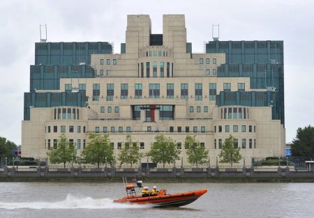 A motorboat passes by the MI6 building in London on August 25, 2010.