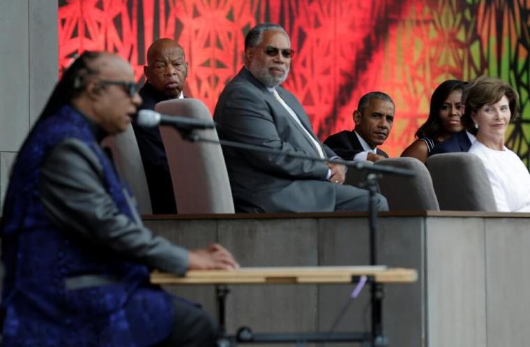 U.S. President Barack Obama with First Lady Michelle Obama and former First Lady Laura Bush listen as Stevie Wonder performs 