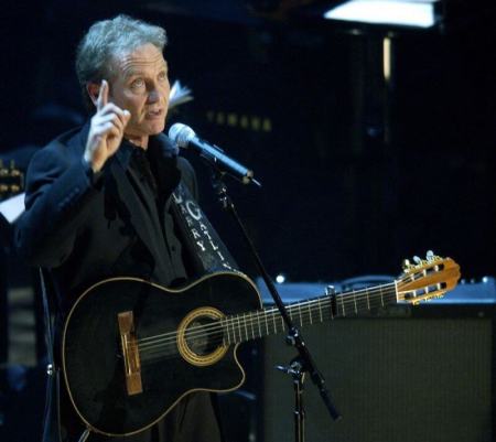 Country music artist Larry Gatlin points to heaven after singing "Diamonds In The Rough," during a tribute to the late country music legend Johnny Cash, at the Ryman Auditorium in Nashville, Tennessee, late November 10, 2003.