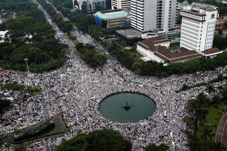 An aerial view shows members of hardline Muslim groups attending a protest against Jakarta's incumbent governor. The protesters, led by a group called the Islamic Defenders Front, chanted