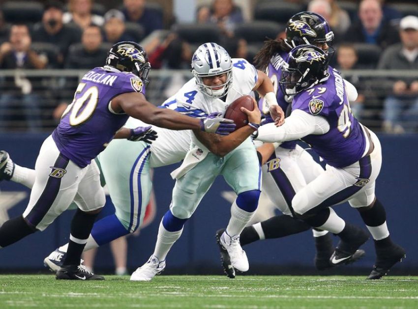 Dallas Cowboys quarterback Dak Prescott (4) is sacked in the first quarter by Baltimore Ravens linebacker Zachary Orr (50) and defensive tackle Timmy Jernigan (99) at AT&T Stadium, Arlington, Texas, November 20, 2016.