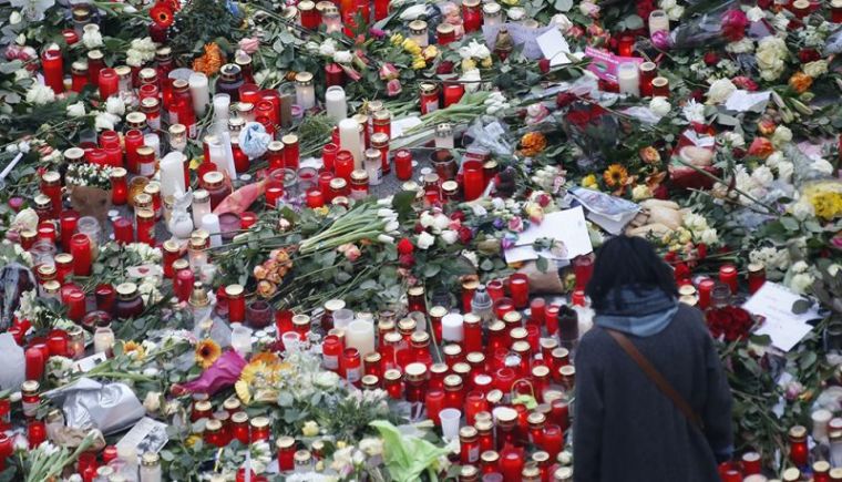 Flowers and candles are placed near the Christmas market in Berlin, Germany, December 21, 2016, after a truck ploughed through a crowd at the Christmas market on Monday night.