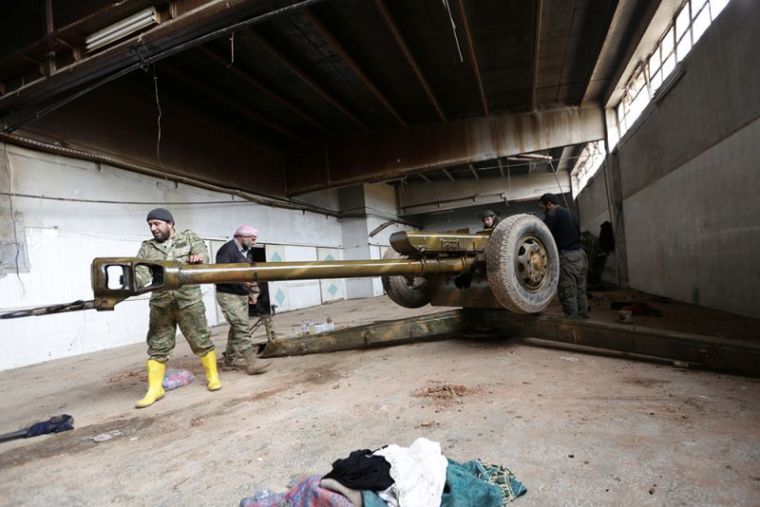 Rebel fighter clean a weapon in al-Rai town, northern Aleppo countryside, Syria, December 25, 2016.