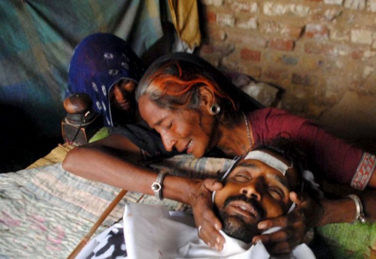 A woman mourns the death of a man who died after consuming bootleg alcohol in Tando Mohammad Khan in Pakistan, March 22, 2016. Local media reported deaths following the consumption of spurious liquor in Tando Mohammad Khan.
