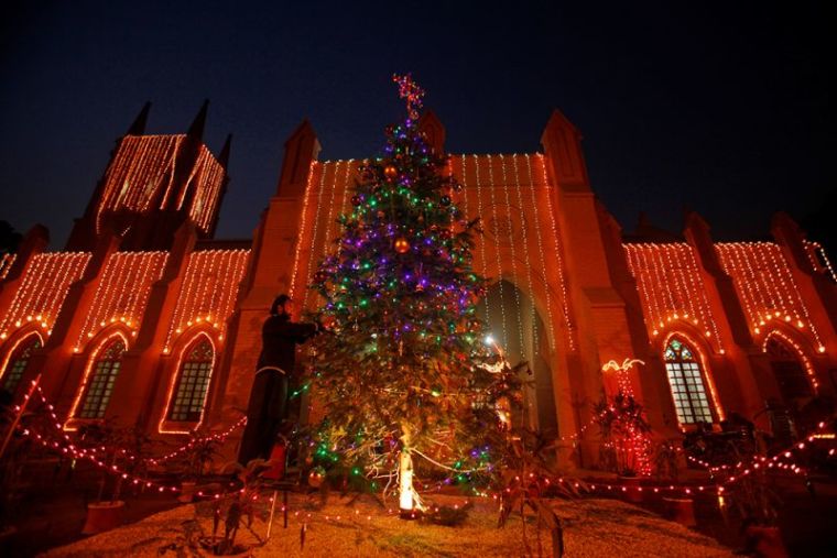 A man decorates a Christmas tree at the St. John Cathedral Church ahead of Christmas celebrations in Peshawar, Pakistan, December 24, 2016.