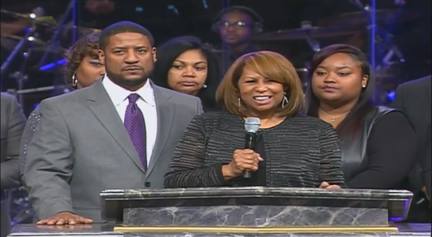Eric Long (L) son of the late Bishop Eddie Long stands at the podium with his mother Vanessa during his father's homegoing service on Wednesday January 25, 2017.