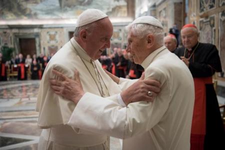 Pope Francis greets his predecessor Pope Emeritus Benedict XVI at the Vatican.