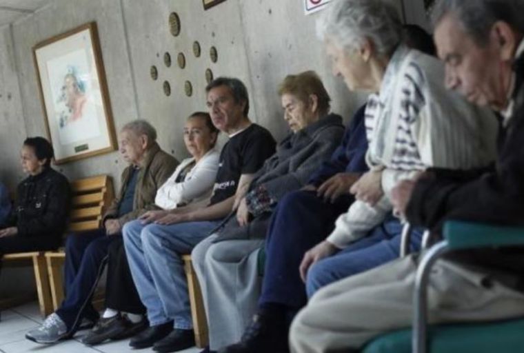 Patients with Alzheimer's and dementia are seated inside the Alzheimer Foundation in Mexico City.