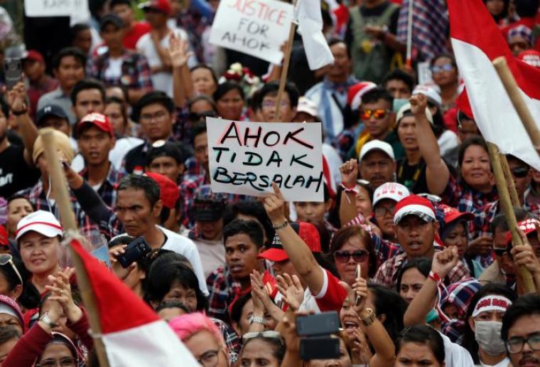 Supporters of Jakarta Governor Basuki Tjahaja Purnama, popularly called Ahok, stage a protest outside Cipinang Prison, where he was taken following his conviction of blasphemy, in Jakarta, Indonesia, May 9, 2017. The sign reads "Ahok is not guilty."
