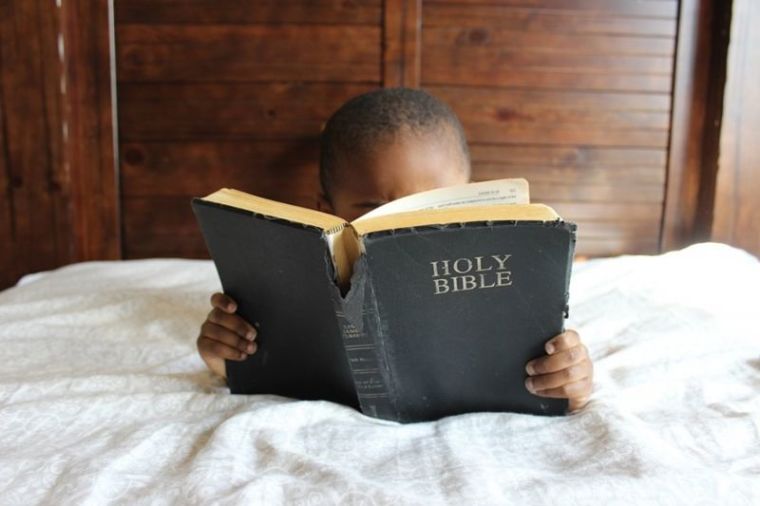 Child reading Bible