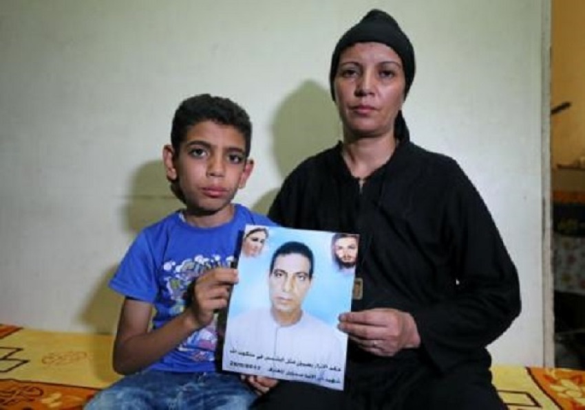 Hanaa Youssef and Mina Habib, the widow and son of a man who was killed in a militant attack against Coptic Christians last month, hold the victim"s portrait in Minya, Egypt June 8, 2017. Picture taken June 8, 2017.