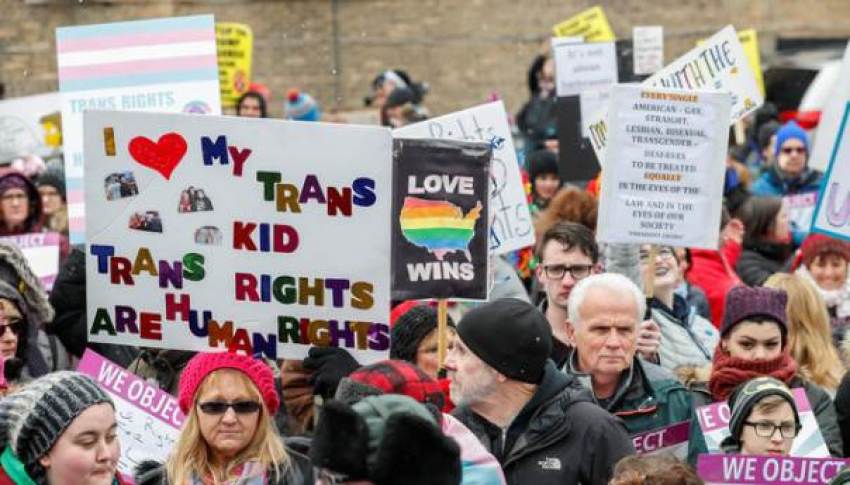 Demonstrators hold signs during "Stand Up for Transgender Rights" event to show their support for transgender equality, in Chicago, Illinois, U.S. February 25, 2017.