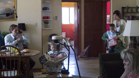 Mitch Davis busily talks on the phone about work while eating breakfast at home surrounded by his three young kids and his wife in 2017 film "The Stray."