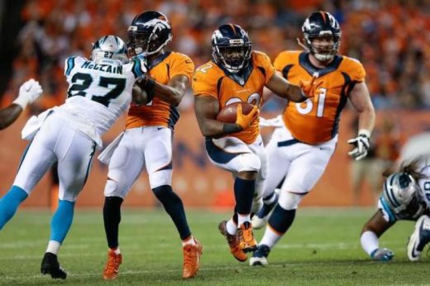 Denver Broncos running back C.J. Anderson (22) runs the ball as wide receiver Jordan Norwood (11).