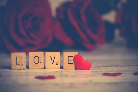 The word "Love" spelled out in Scrabble letters.