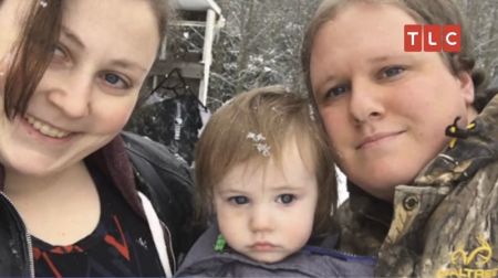 Stacy(L) and Les (R), stars of the upcoming TLC series "Lost in Transition" pose for a picture with their baby.