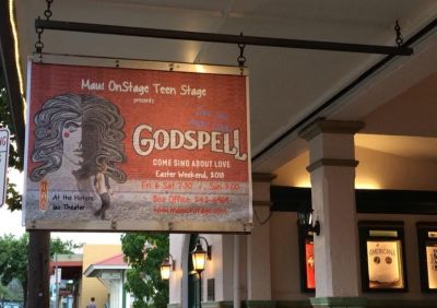 A sign advertising a production of the 1970s musical "Godspell."
