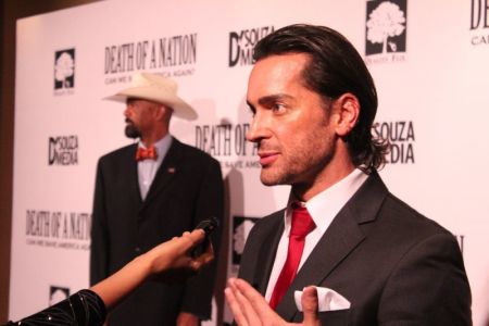 Brandon Straka speaks to reporters at the advanced screening of Dinesh D'Souza's documentary