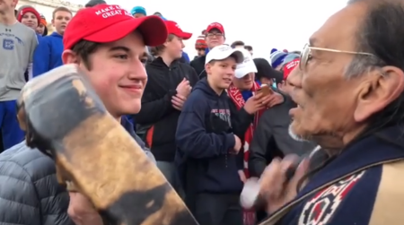 Nicholas Sandmann (L), a junior at Covington Catholic High School in Kentucky, smiles at Nathan Phillips (R), an Omaha elder and Vietnam War veteran as he played a ceremonial drum on Friday January 18, 2019, during a clash between the March for Life and the Indigenous People's rally. in Washington, D.C.