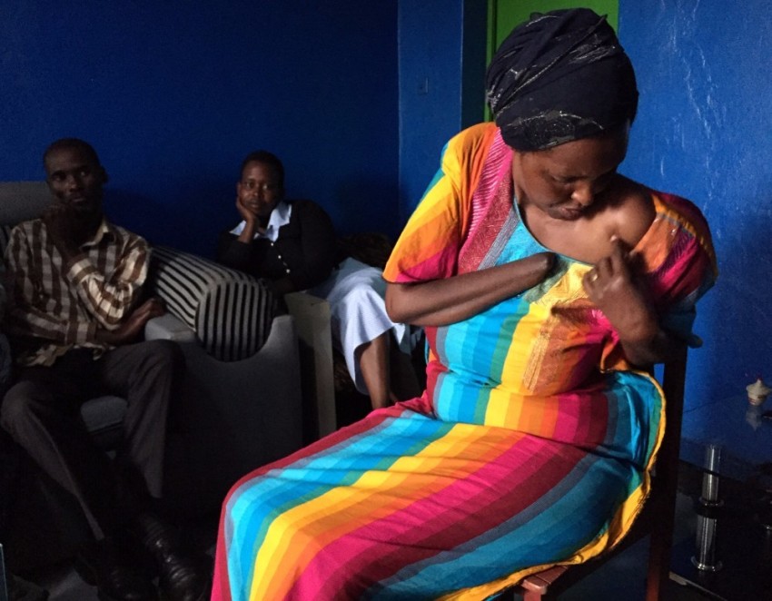 Alice Mukarurinda (R) shows the scar that remains from being speared in the shoulder by one of the colleagues of Emmanuel Ndayisaba (L). She also has scars remaining on her head in addition to the loss of her hand. The two are now are now good friends despite being victim and perpetrator during the Rwandan genocide of 1994.