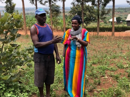 Alice Mukarurinda (R) eats kernels of roasted corn given to her by Baroshiman Canisius (L) in Nyamata, Rwanda on Feb. 18, 2019. Canisius is one of the perpetrators that asked Mukarurinda for forgiveness following the Rwandan genocide in 1994.