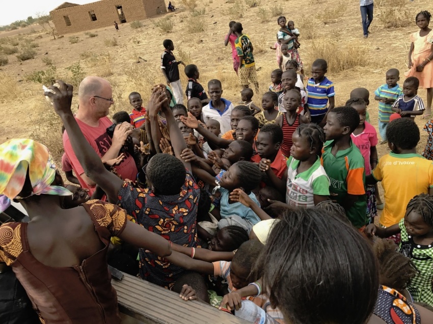 Jeff Riddering is surrounded by children on his visit to West Africa in March 2018.
