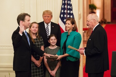 President Donald J. Trump looks on as Anthony M. Kennedy, retired Associate Justice of the Supreme Court of the United States, swears in Judge Brett M. Kavanaugh to be the Supreme Court's 114th justice Monday, Oct. 8, 2018, in the East Room of the White House in Washington, D.C. Justice Kavanaugh is joined by his wife Ashley, holding the Bible, and their daughters Liza and Margaret.