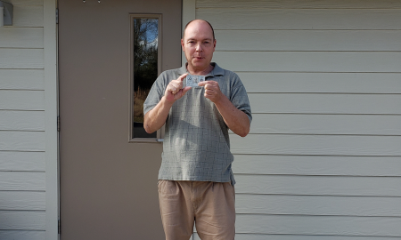 Jamie Shupe poses with his military identification card, which now recognizes his actual biological sex, male.