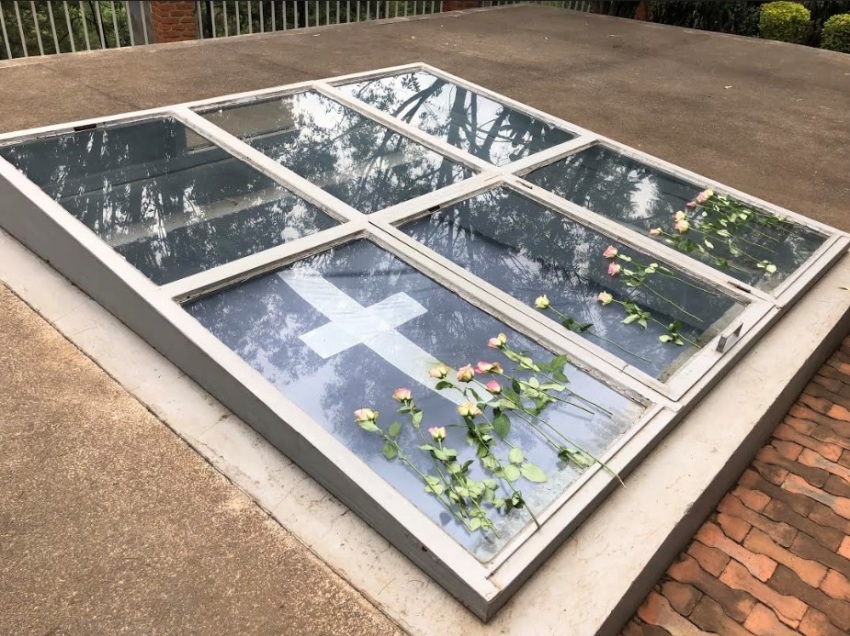 Roses lay atop a mass grave of Rwandan genocide victims at a genocide memorial in the capital city of Kigali, Rwanda in February 2019. At this genocide memorial lays the remains of over 250,000 people.