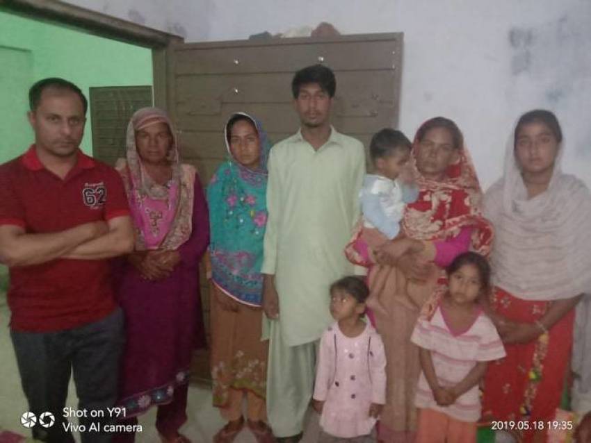 Zeeshan Masih of BPCA (left) poses with members of the Masih family in Arif Wala Tehsil district in the Punjab province of Pakistan in May 2019.