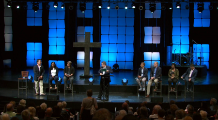 Eight of the nine members of Willow Creek Community Church's elder board promote unity at a Worship & Reflection Service.