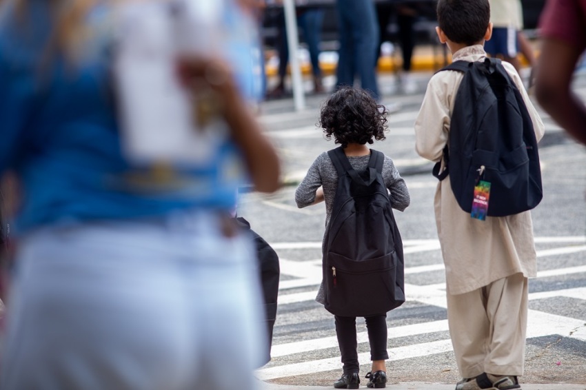 Children walk with backpacks they were given at the "Back to School Party" held at the Send Relief Ministry Center in Clarkston, Georgia on Aug. 3, 2019.