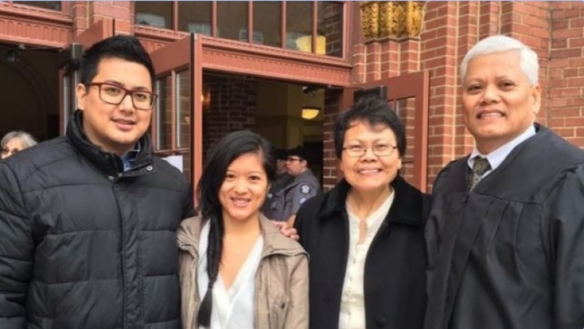 Edgardo (right) and Julita Bartolome (center-right) pose for a photo with Edgardo's two children.