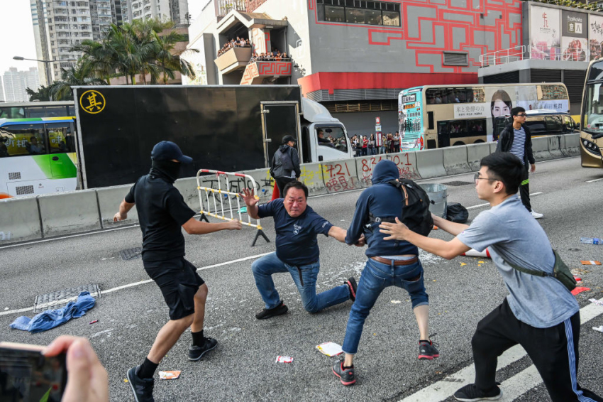 Protesters react as a truck driver clears the barricades on the road in Wong Tai Sin district on November 11, 2019, in Hong Kong, China. Anti-government protesters organized a general strike on Monday as demonstrations in Hong Kong stretched into its sixth month with demands for an independent inquiry into police brutality, the retraction of the word "riot" to describe the rallies, and genuine universal suffrage.