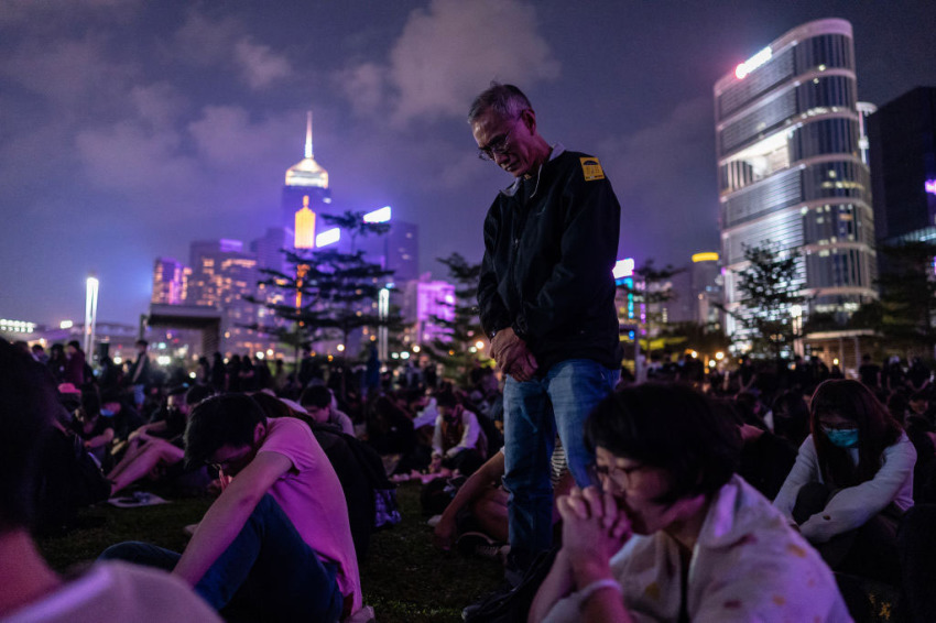 People take a moment of silence during a remembrance prayer in memory of university student Alex Chow, who succumbed to head injuries sustained during a fall as police skirmished with demonstrators. Photo taken on November 9, 2019, in Hong Kong, China. 