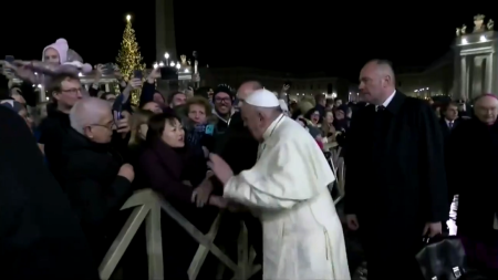 Pope Francis slaps an admirer who grabbed him aggressively as he greeted pilgrims around the Vatican’s giant Nativity scene after a New Year’s Eve liturgy.