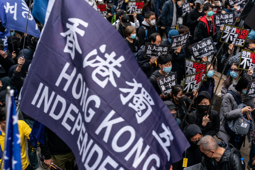 Pro-democracy supporters hold placards and shout slogan as they take part in a march during a rally on New Years Day on January 1, 2020, in Hong Kong, China. Anti-government protesters in Hong Kong continue their demands for an independent inquiry into police brutality, the retraction of the word "riot" to describe the rallies, and genuine universal suffrage.