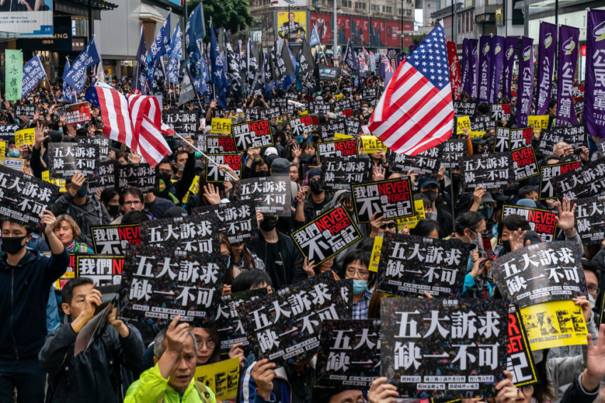 Pro-democracy supporters hold placards and shout slogan as they take part in a march during a rally on New Years Day on January 1, 2020, in Hong Kong, China.