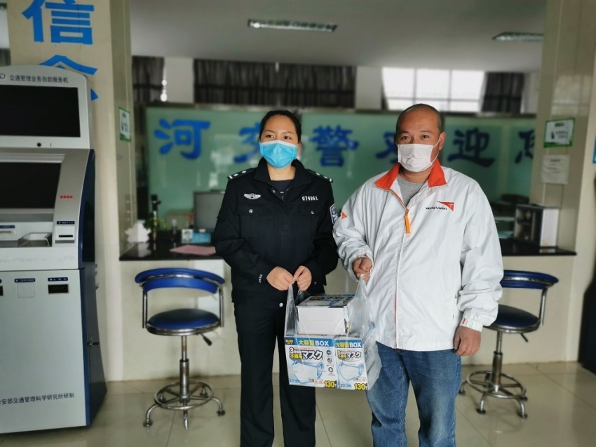 A World Vision worker holds up boxes of facemasks during the 2019-2020 coronavirus outbreak in China.