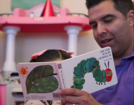 Texas father, "Chris," reads to his daughter, "Ann," in a Facebook video posted on April 21, 2020.