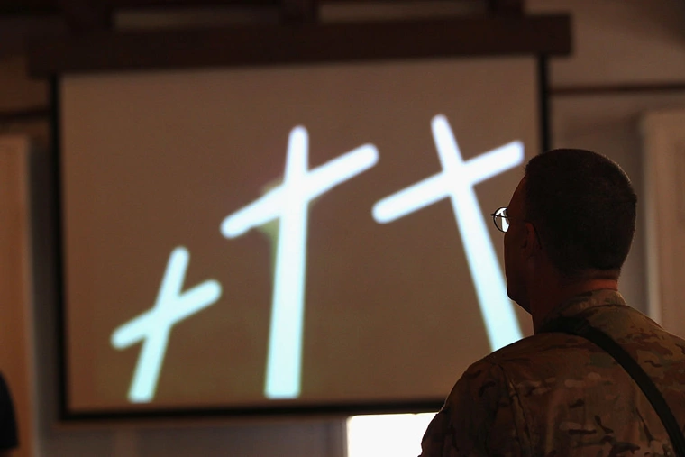 U.S. Army soldiers pray on September 11, 2011 during a protestant service at Bagram Air Field, Afghanistan. Ten years after the 9/11 attacks in the United States and after almost a decade war in Afghanistan, American soldiers gathered for church services in prayer and solemn observance of the tragic day. | John Moore/Getty Images