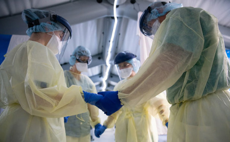 Samaritan's Purse medial team in prayer at a a field hospital in Cremona, Italy, 2020.