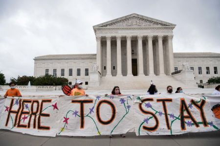 Activists hold a banner in front of the US Supreme Court in Washington, DC, on June 18, 2020. The U.S. Supreme Court rejected President Donald Trump's move to rescind the DACA program that offers protections to 700,000 undocumented migrants brought to the US as children.
