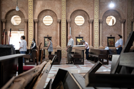 Damaged furniture is seen in the foreground as people attend Sunday mass at the partially damaged St. Antoine Church on August 16, 2020, in Beirut, Lebanon. The explosion at Beirut's port last week killed over 200 people, injured thousands, and upended countless lives. There has been little visible support from government agencies to help residents clear debris and help the displaced, although scores of volunteers from around Lebanon have descended on the city to help clean.