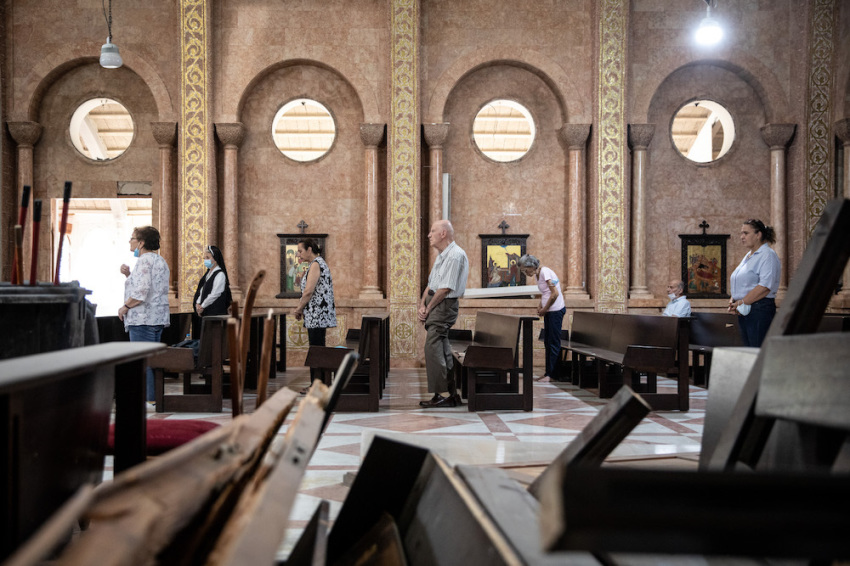Damaged furniture is seen in the foreground as people attend Sunday mass at the partially damaged St. Antoine Church on August 16, 2020, in Beirut, Lebanon. The explosion at Beirut's port last week killed over 200 people, injured thousands, and upended countless lives. There has been little visible support from government agencies to help residents clear debris and help the displaced, although scores of volunteers from around Lebanon have descended on the city to help clean.
