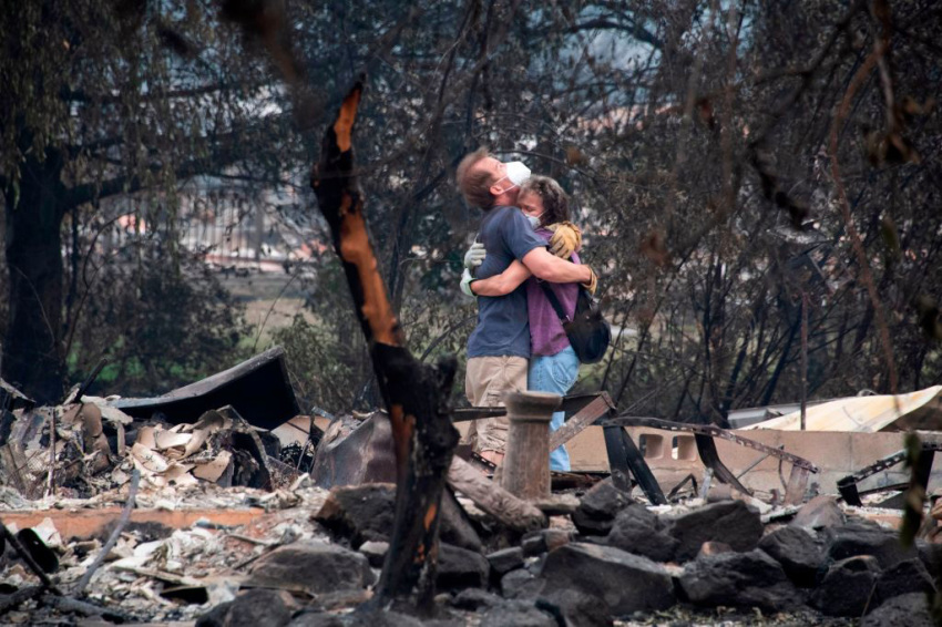 Dee Perez comforts Michael Reynolds in the ruins of his home destroyed in the Almeda Fire in Talent, Oregon, September 15, 2020. Infernos across California, Oregon and Washington state have burned more than 5 million acres (2 million hectares) this year, killed dozens of people and forced hundreds of thousands from their homes.