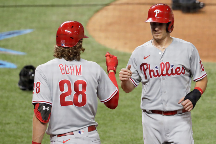 J.T. Realmuto of the Philadelphia Phillies, celebrates with Alec Bohm after scoring on a wild pitch by James Hoyt of the Miami Marlins at Marlins Park on September 12, 2020, in Miami, Florida.