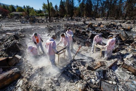 Samaritan's Purse volunteers sift through a burned-down home in Jackson County, Oregon, in the wake of a wildfire in September 2020.