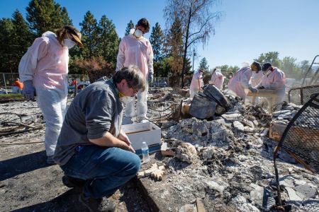 Samaritan's Purse volunteers help homeowner Stephen MacAulay sift through the ash of his burned-down home in Jackson County, Oregon, following a wildfire in September 2020.